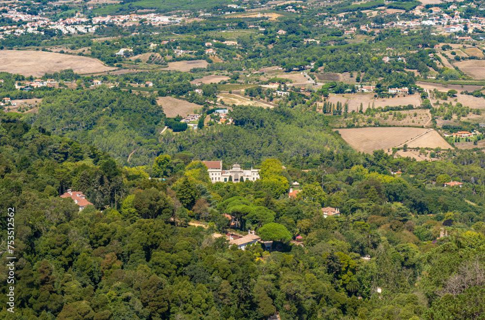 Aerial drone view of the Seteais Palace in Sintra, Portugal, with the entire green mountain range around and luxury chalets.