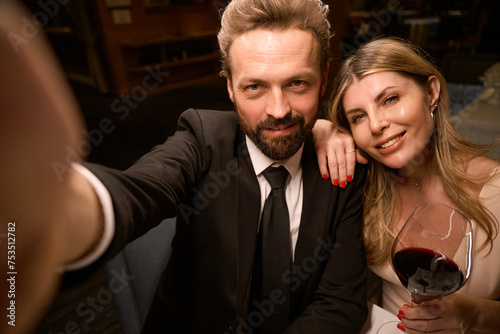 Elegant couple taking a selfie in a restaurant