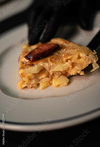 Traditional Spanish omelette cooked with chorizo, potatoes and onion. Traditional tapas of Spanish gastronomy.