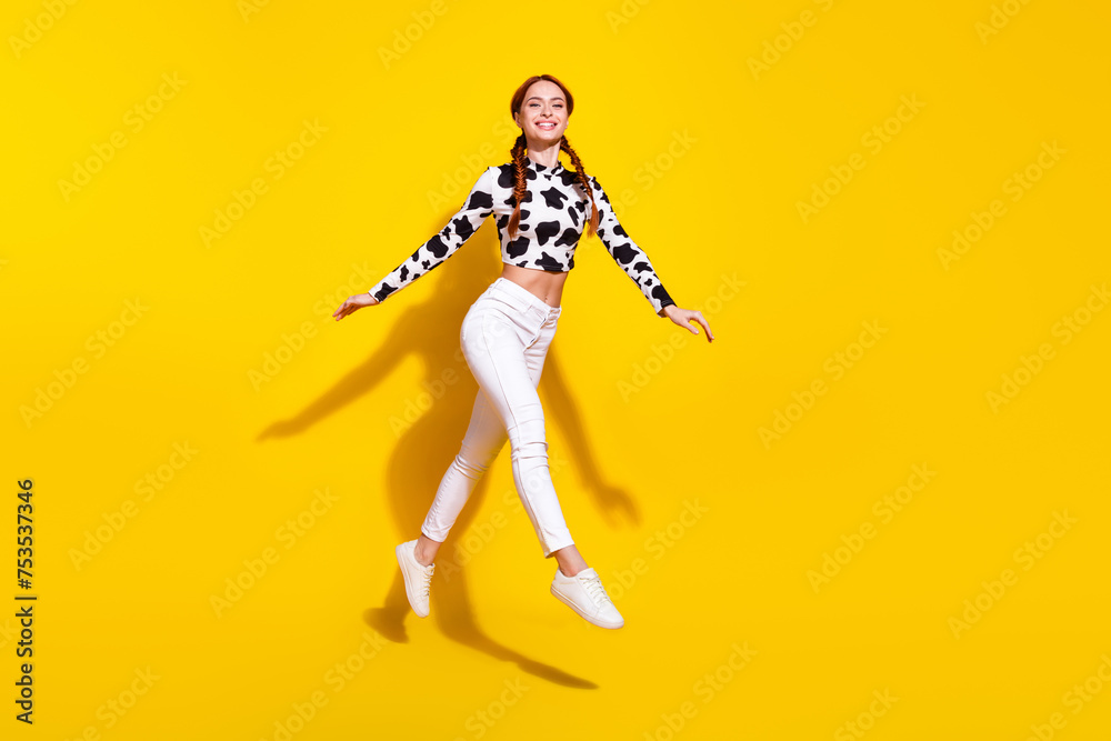 Full body profile portrait of gorgeous cheerful lady jump empty space isolated on yellow color background