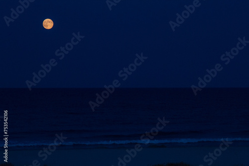 The moon  over the beautiful beach of La Caletta, Siniscola in Sardinia, Italy photo