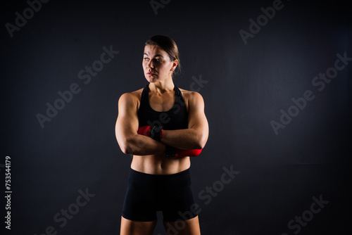 Young woman athletic female MMA fighter training. Concept of sport, action, healthy lifestyle.