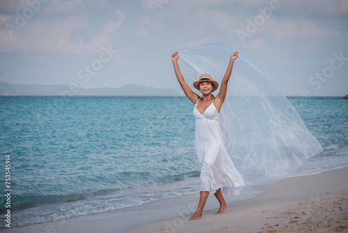 Εκτύπωση καμβά Happy sexy Asian traveller woman wear white beach dress and hat show enjoys on t