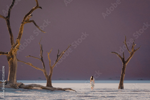 Woman walking in Dead Vllei, Sossusvlei, Namibia