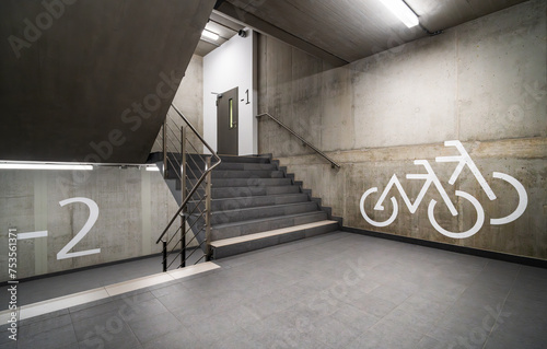 Staircase in an office building. Underground bicycle parking. Empty space. Concrete walls. photo