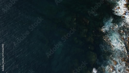 Flying view down first going slowely up to the coast of spain in the atlantic. Early morning. Beautiful green forest in the back. . High quality 4k footage photo