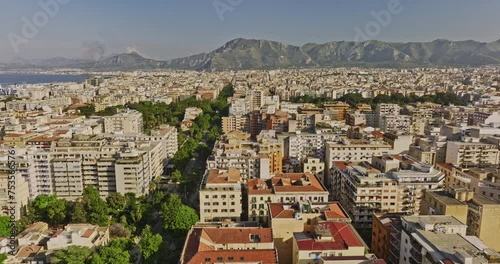 Palermo Italy Aerial v12 fly along Via della Liberta capturing leafy street, cityscape across residential and downtown areas, city park and mountain on the skyline - Shot with Mavic 3 Cine - May 2023 photo