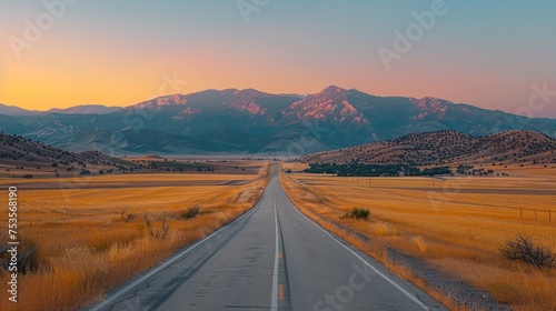 A long road stretches across a dry  barren landscape