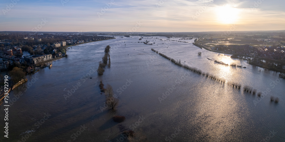 Panorama aerial showing extreme high water level of river IJssel in Zutphen, The Netherlands with inundated floodplains and waterway out of its normal flow riverbanks Panorama aerial showing extreme high water level of river IJssel in Zutphen, The Netherlands with inundated floodplains and waterway out of its normal flow riverbanks