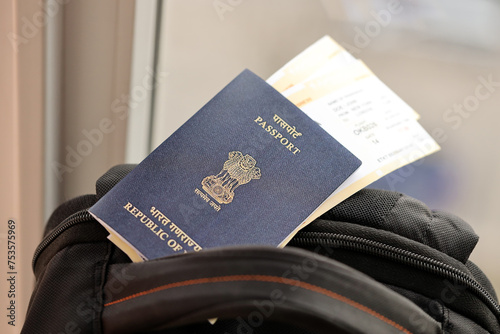 Blue Indian passport with airline tickets on touristic backpack close up. Tourism and travel concept