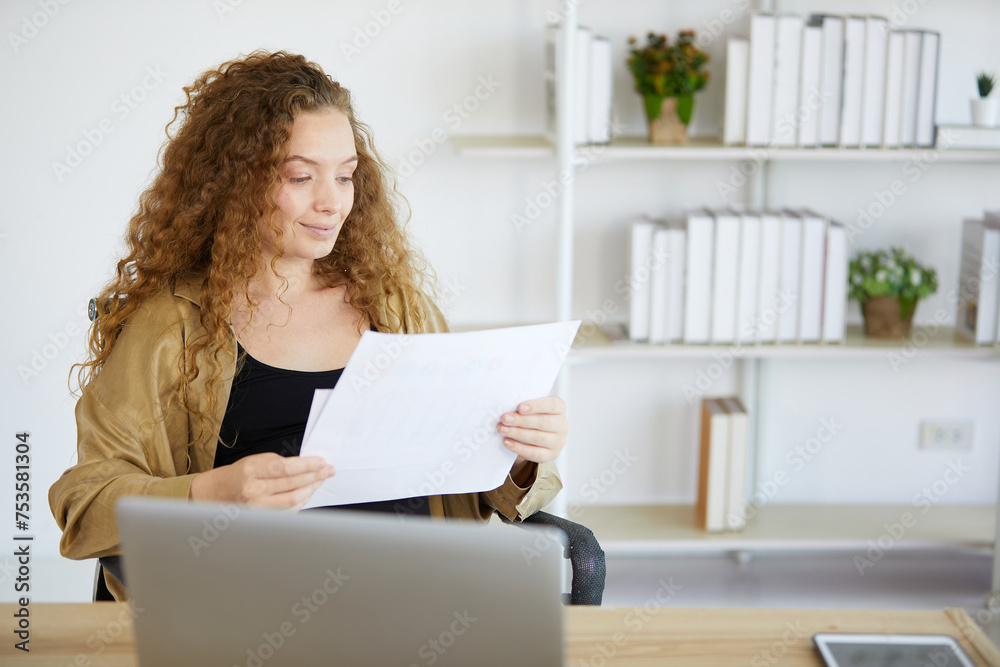 businesswoman holding and reading document paper in the office businesswoman holding and reading document paper in the office