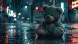 Abandoned teddy bear on rainy city street