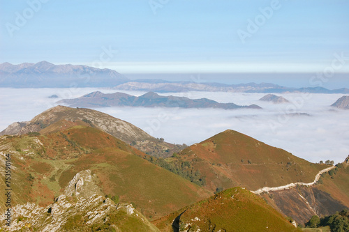 Photography misty landspace with a sea of clouds below the mountains