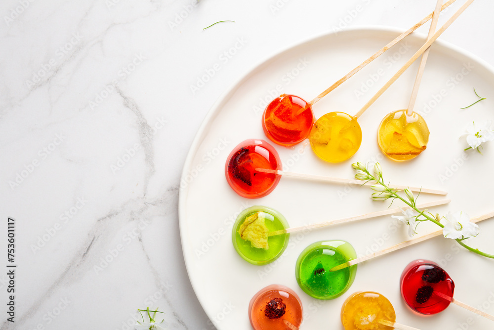 Sugar fruits lollypop candy on light surface top view Sugar fruits lollypop candy on light surface top view