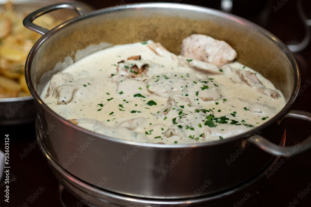 chicken in white sauce, chicken in silver bowl, buffet
