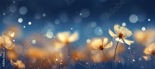 Cozy Christmas golden ice flowers on the snow background with yellow and blue bokeh hues. Festive  uplifting wallpaper backdrop
