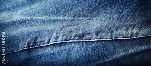 A close-up view of a pair of blue denim jeans, showing the texture of the fabric, stitching details, and any worn-in features like fades or distressing.