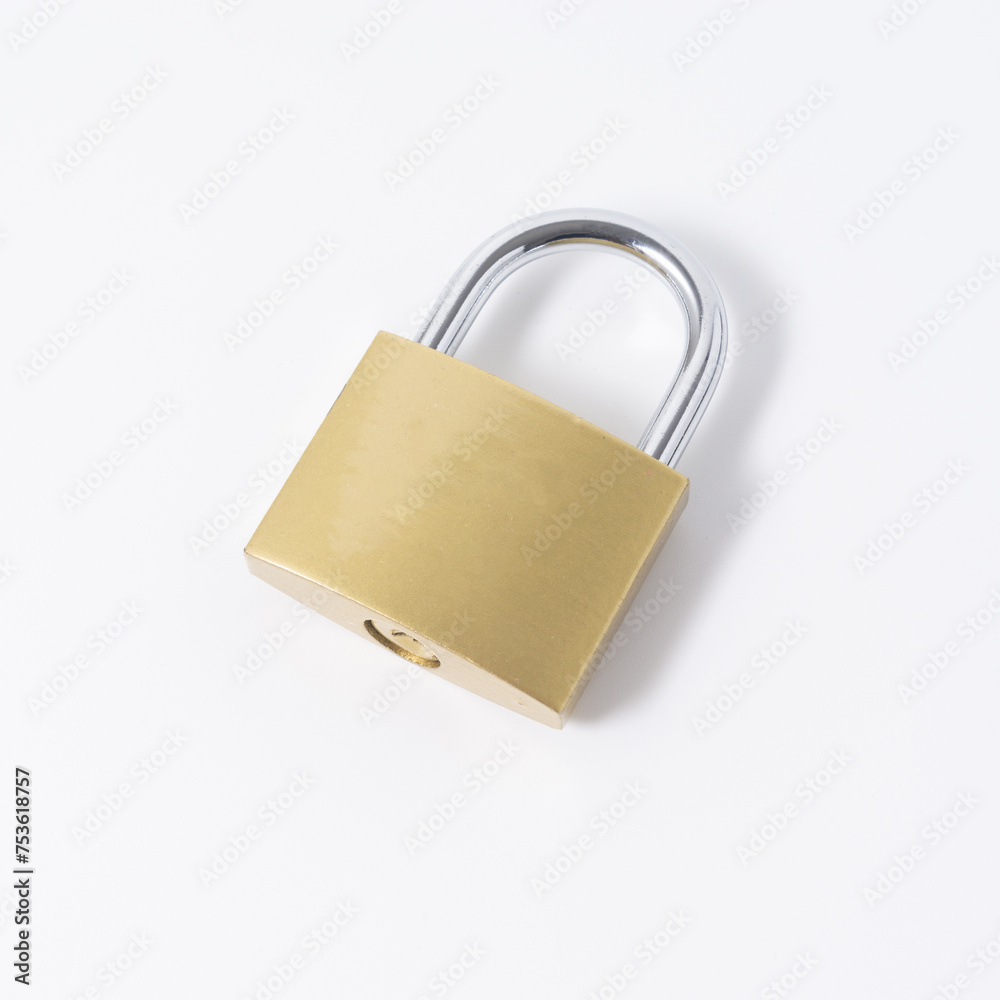 Closeup shot of a brass padlock isolated on a white background Closeup shot of a brass padlock isolated on a white background