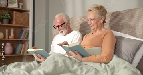 Elderly couple reading books in bed
