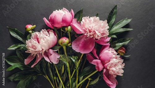 beautiful bouquet of pink peonies on a black background vertical flower arrangement in a dark key flat lay moody floral