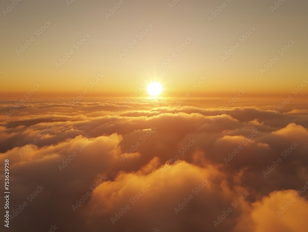 A serene sunrise scene with warm colors reflecting off fluffy clouds.