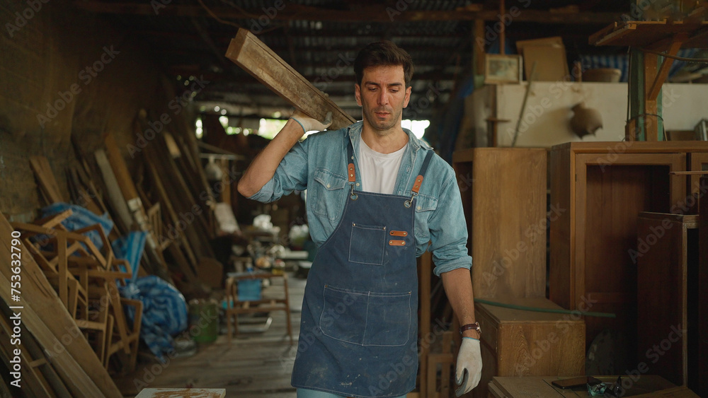Young carpenter man working on woodworking in the furniture factory. Carpenter man making woodcraft furniture in wood workshop look professional high skill people workman Young carpenter man working on woodworking in the furniture factory. Carpenter man making woodcraft furniture in wood workshop look professional high skill people workman