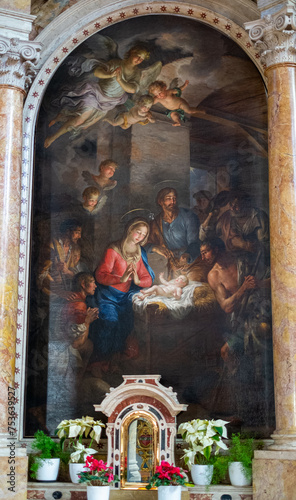 Painting of baby Jesus in the cradle with Mary at his side