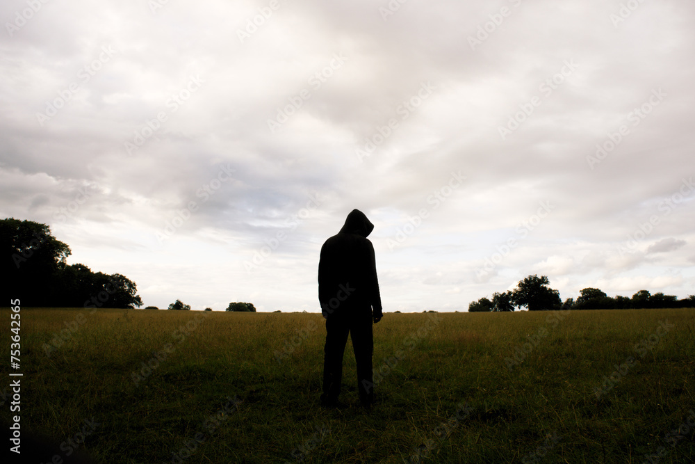 A mysterious hooded figure. Standing in a field. With a spooky, moody edit. A mysterious hooded figure. Standing in a field. With a spooky, moody edit.