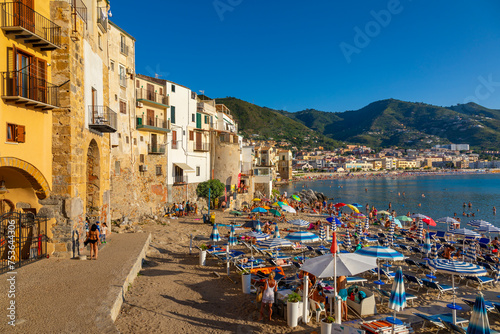 Tourists on beach, Cefalu, mountains in background, Province of Palermo, Sicily, Italy photo
