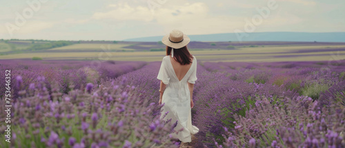 Woman enjoying a serene moment alone in a vibrant lavender field.