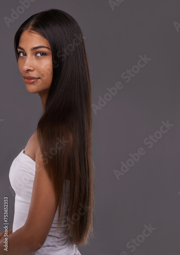 Hair care, portrait and beauty of woman, skincare and mockup space isolated on gray studio background. Hairstyle, face and Indian model in makeup cosmetics at salon for body treatment at hairdresser