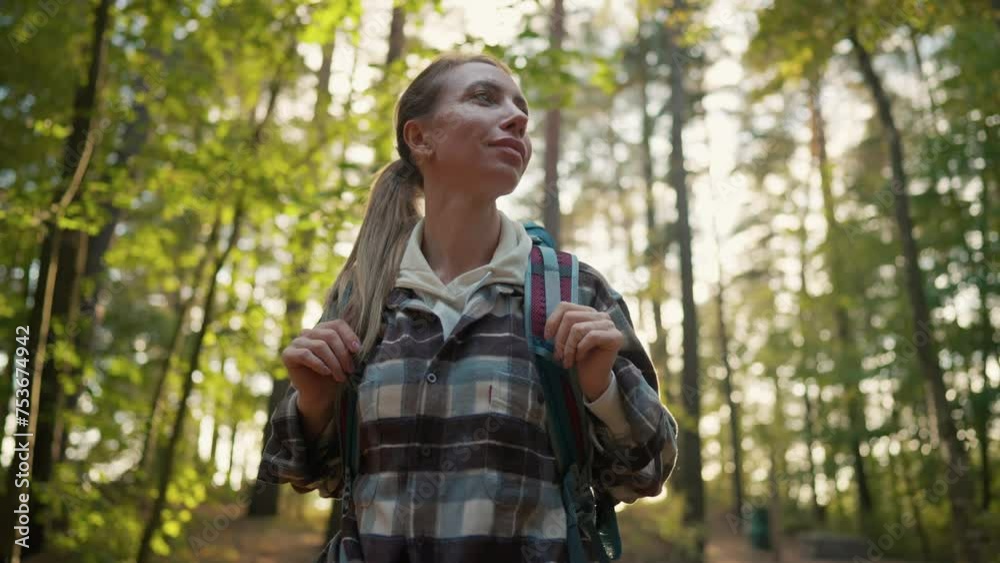 Woman enjoying wild nature in forest. Female optimistic tourist traveler hiker carrying backpack with equipment. Outdoor activity on vacations in woodland. Travel tourism trip trekking concept. Woman enjoying wild nature in forest. Female optimistic tourist traveler hiker carrying backpack with equipment. Outdoor activity on vacations in woodland. Travel tourism trip trekking concept.
