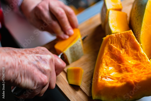 Cutting a pumpkin in the kitchen for cooking and freezing