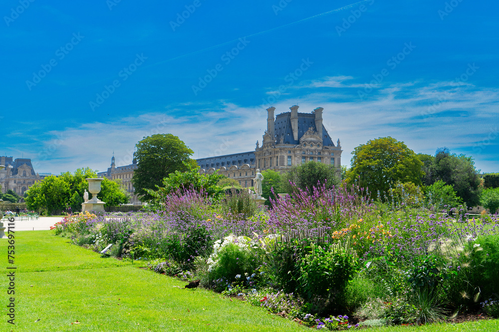 Summer holidays in Paris. Tuileries gardens in front of Louvre palace, Paris France.