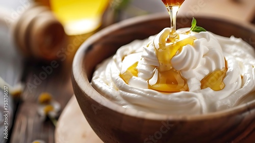 Drizzling honey over a bowl of Greek yogurt