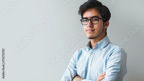 Portrait of a young Latin boy, in formal clothing. Studio shot, on white background.