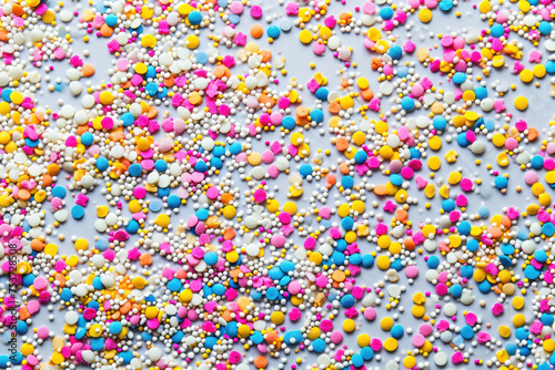 Assorted Colorful Sprinkles on White Background with Blue, Yellow, Pink and White Color Scheme