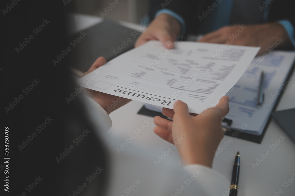 Close up view of job interview in office, focus on resume writing tips, employer reviewing good cv of prepared skilled applicant, recruiter considering application, hr manager making hiring decision Close up view of job interview in office, focus on resume writing tips, employer reviewing good cv of prepared skilled applicant, recruiter considering application, hr manager making hiring decision