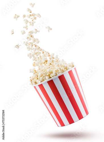 Popcorn flying from red and white striped container, isolated on white background.