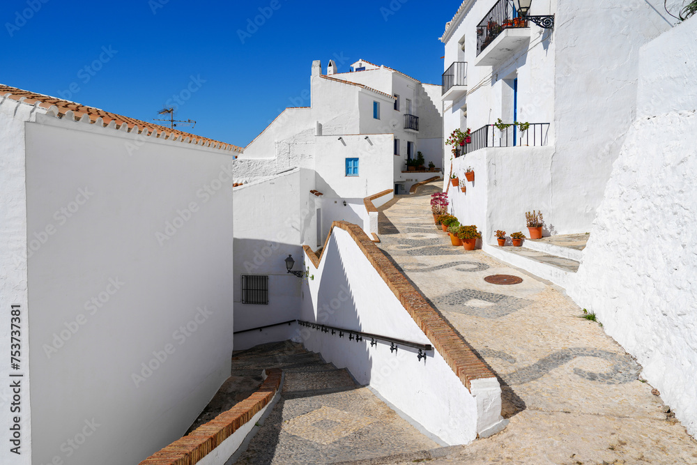Charming mosaic streets in white hillside village of Frigiliana Spain