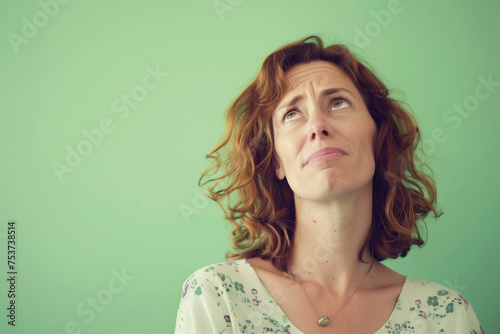 a photograph of a 45 year old mother who is confused, light green background. AI Generated photo