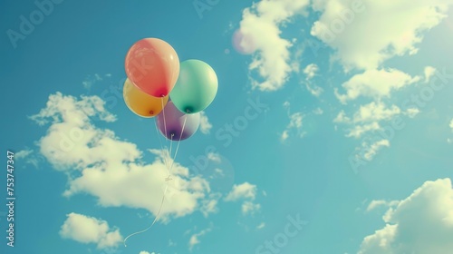 one multi-colored balloon flying in the summer sky