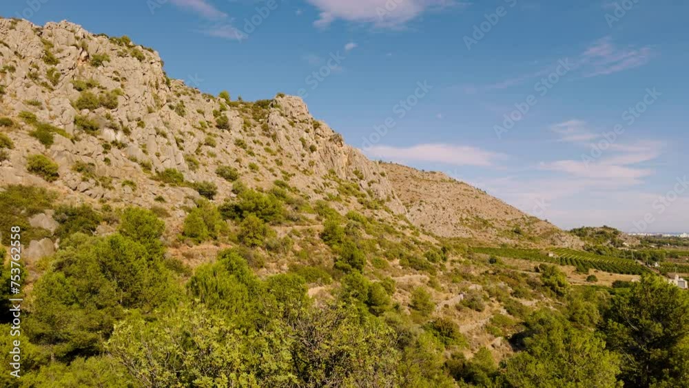 City of Benicassim on the Mediterranean Sea in Spain. Panorama from the hill to the city of Benicassim near the Mediterranean Sea. The green path between the stones is a popular place for outdoor City of Benicassim on the Mediterranean Sea in Spain. Panorama from the hill to the city of Benicassim near the Mediterranean Sea. The green path between the stones is a popular place for outdoor