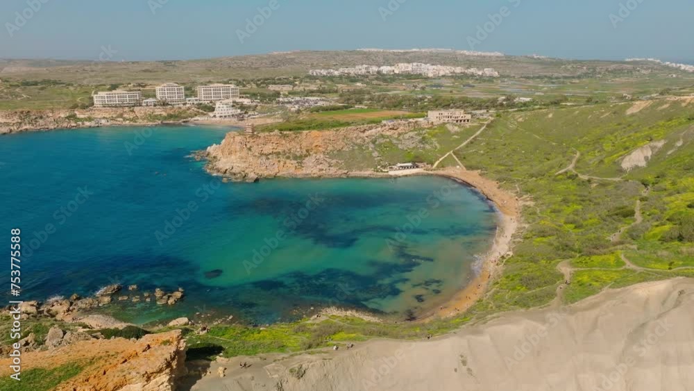 Aerial drone view of maltese bay and beach. Spring, green countryside. Ghain Tuffieha, Malta island