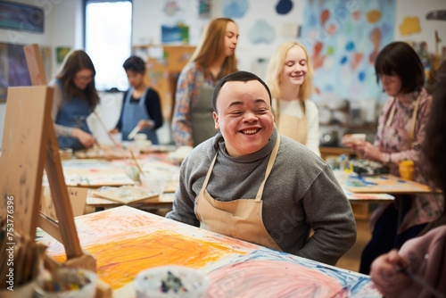 Young smiling man with Down syndrome on art workshop with a group of students high resolution --ar 3:2 Job ID: e562660a-8c61-4cbb-bad6-aef6c8ec51cf