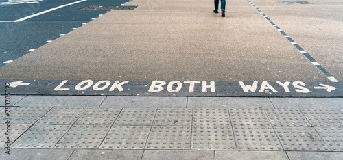 Look both ways written on a pedestrian crossing
