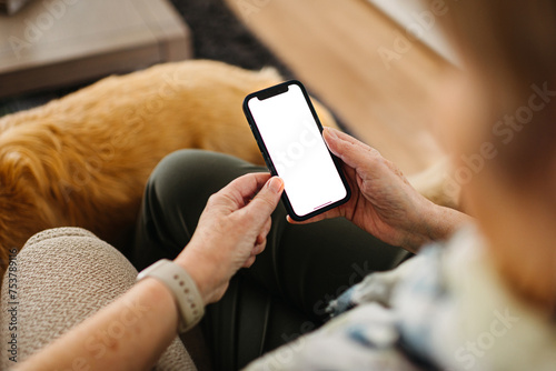 Older woman with white screen at phone. Mockup Phone