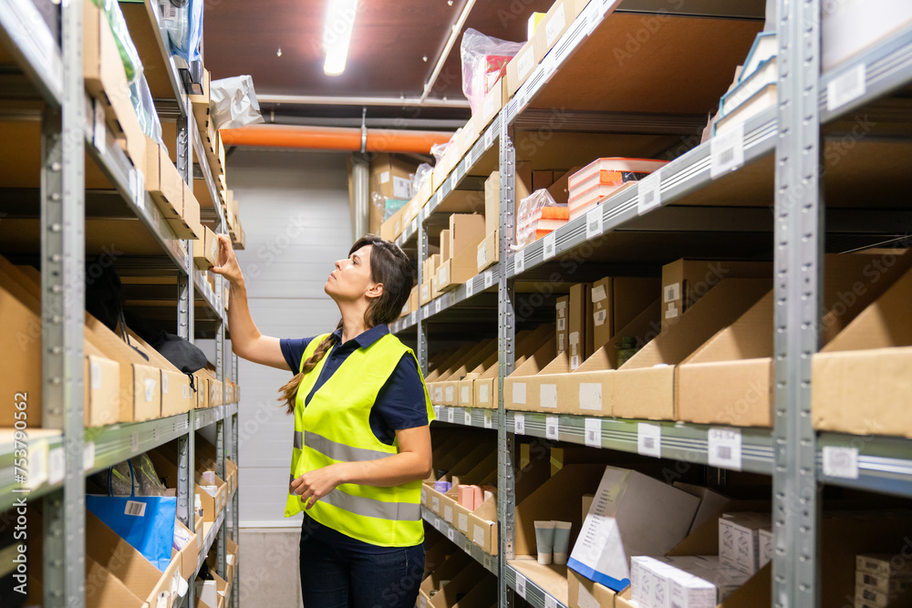 Worker Searching For Goods At Warehouse Storage Worker Searching For Goods At Warehouse Storage