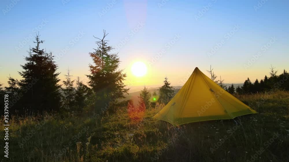 Camping tent on trekking trail for hikers shelter. Mountain campsite at bright sunset. Active tourism and hiking concept Camping tent on trekking trail for hikers shelter. Mountain campsite at bright sunset. Active tourism and hiking concept