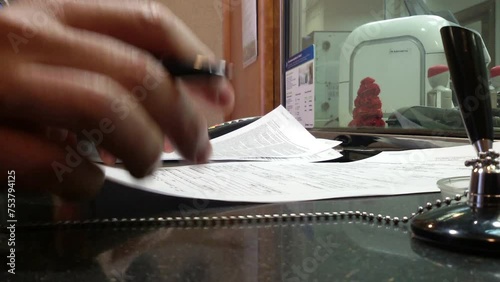 Close-up of a man in a bank signs a contract. photo